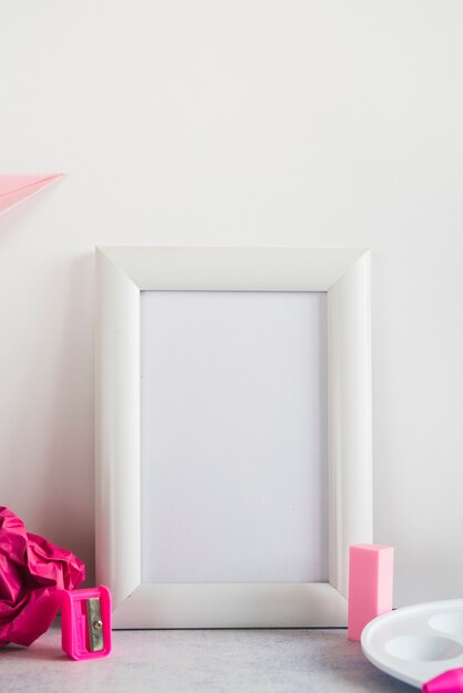 Blank frame and supplies on desk