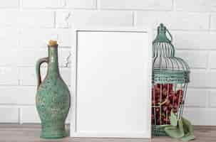 Free photo blank frame with flagon and grape beside