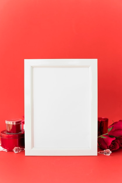 Blank frame with roses on table