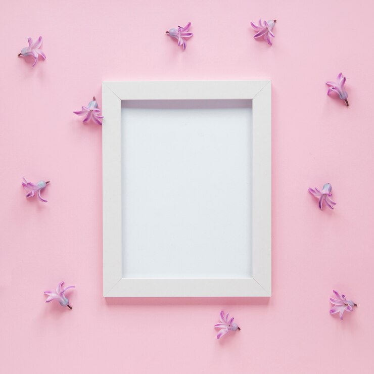 Free Photo blank frame with small purple flowers on table 