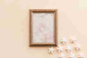 Free photo blank frame with small stars on table