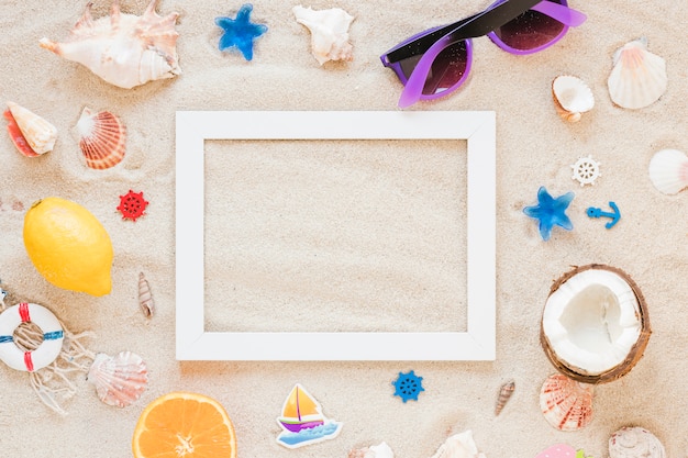 Blank frame with sunglasses and sea shells