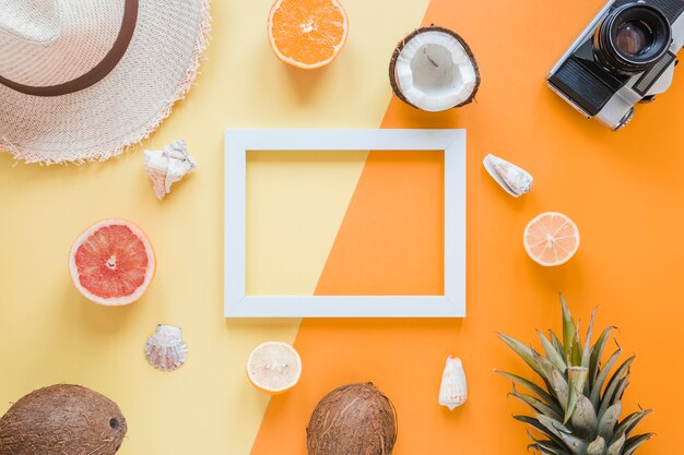 Blank frame with travel accessories, fruits and shells