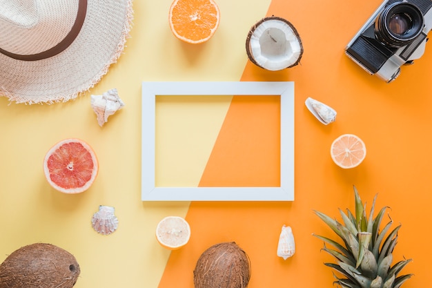 Blank frame with travel accessories, fruits and shells