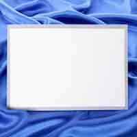 Free photo blank greetings card or invitation with blue satin background.