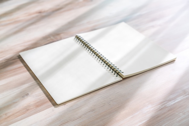 Free photo blank notebook mock up on wood background