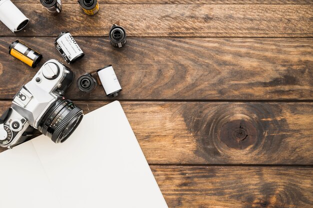 Blank notebook near camera and cartridges