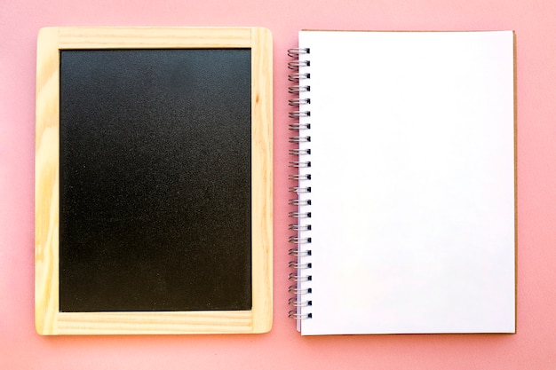 Free photo blank notebook near chalkboard