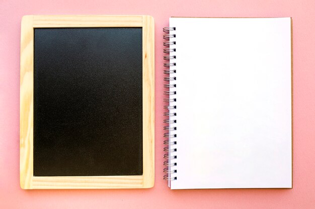 Blank notebook near chalkboard