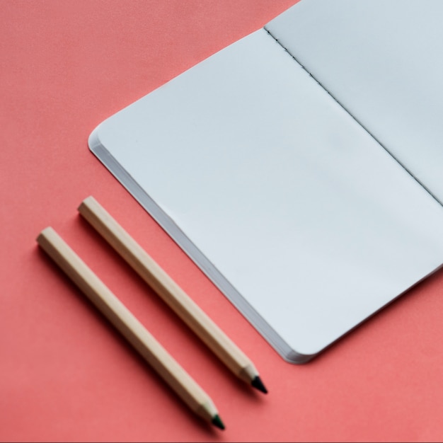 Blank notebook and pencil isolated on background