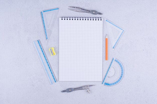 Blank notebook with ruler and pens around