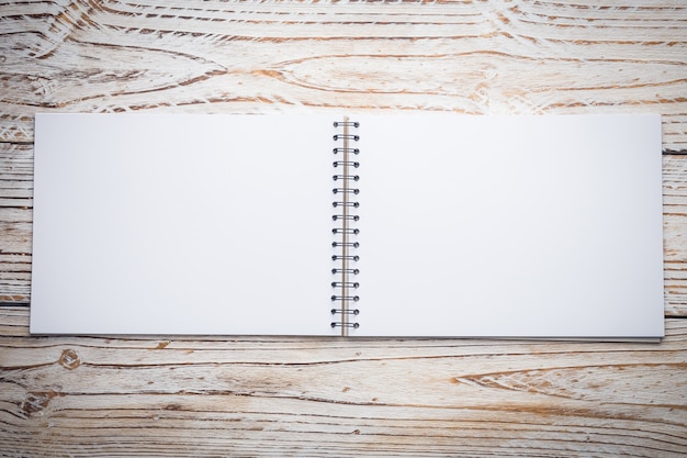 Blank notebook on wooden background