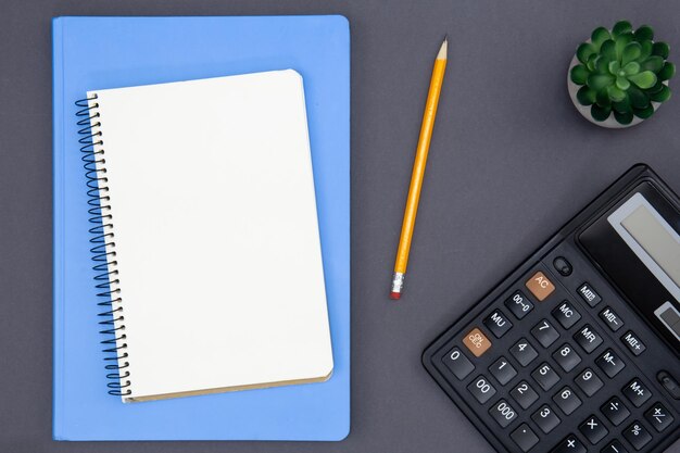 Blank notepad calculator and pencil top view