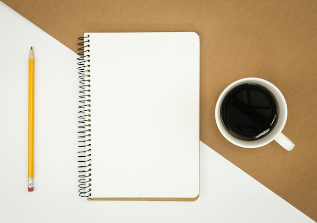 Free photo blank notepad coffee cup and pencil flat lay