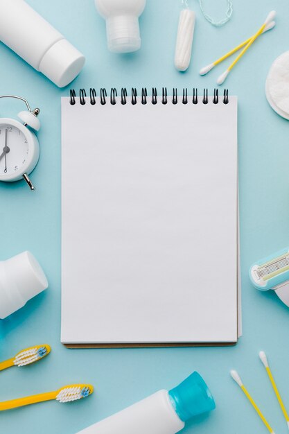 Blank notepad surrounded by hygiene products