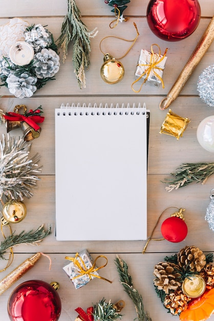 Blank notepad with baubles on table 