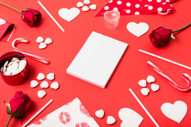 Blank notepad with hearts on table