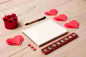 Free photo blank notepad with i love you inscription on table