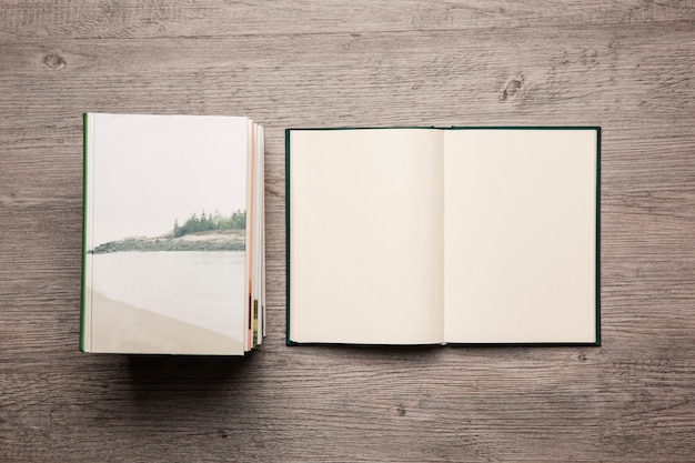 Free photo blank open books next to stack of books