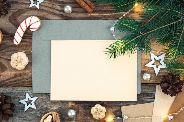 Free photo blank paper envelope and christmas decor on wooden background copy space