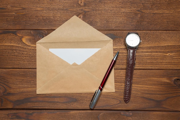 Blank paper, envelope on wooden table