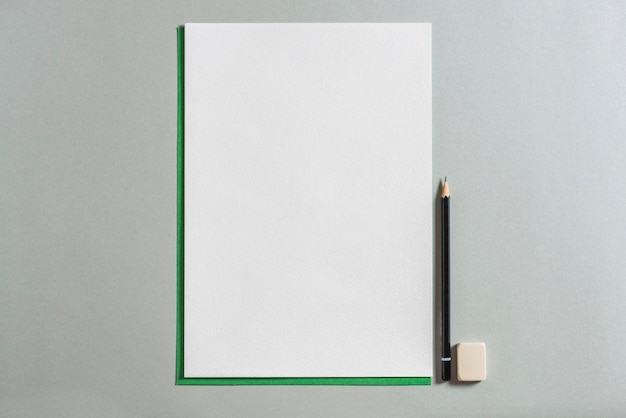 Free photo blank paper, pencil and eraser on grey background