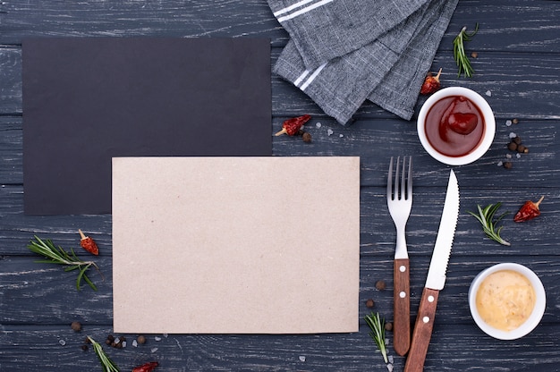 Free photo blank paper sheet with cutlery