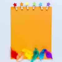 Free photo blank paper sheet with rainbow feathers