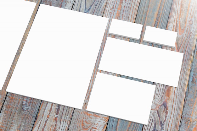 Free photo blank paper stationery set on wooden desk