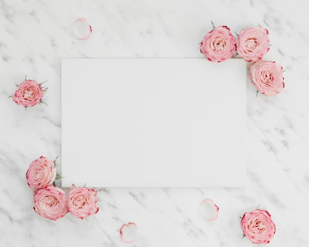Blank paper surrounded by flowers
