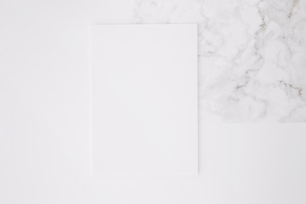 Blank paper on white desk background