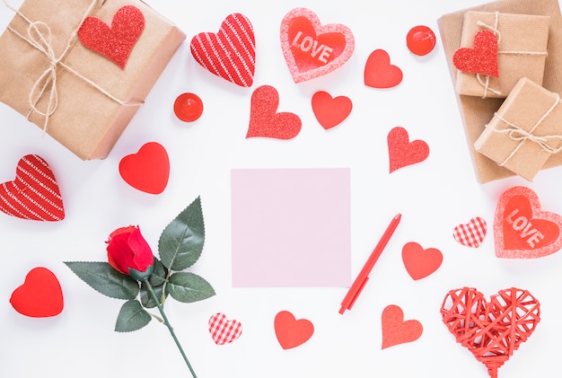 Blank paper with gift boxes on table