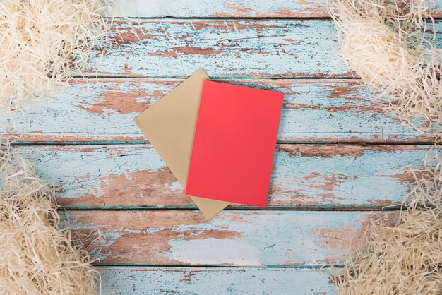 Blank papers with decorative straw on table