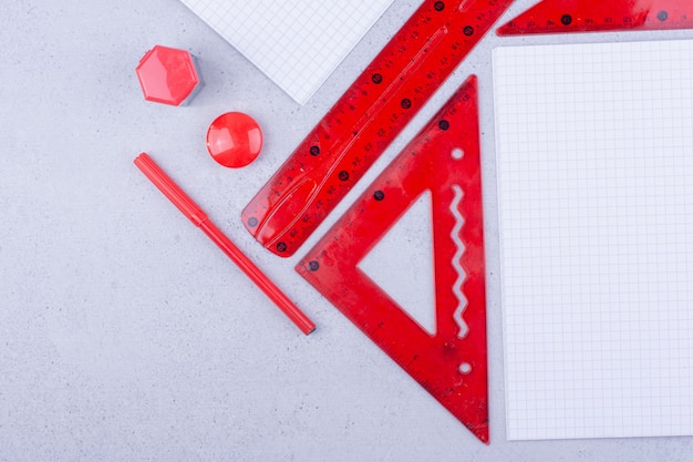 Blank papers with red pins and rulers