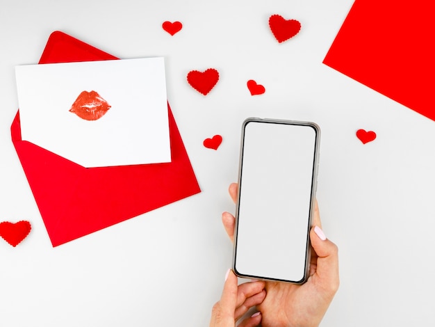 Foto gratuita telefono in bianco accanto alla lettera d'amore