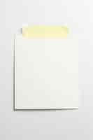 Free photo blank photo frame with soft shadows and yellow scotch tape isolated on white paper background