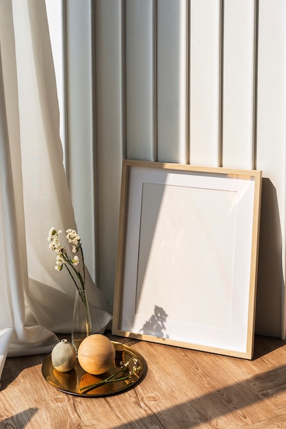 Blank Picture Frame By A White Wall On The Wooden Floor