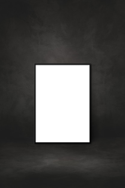 Blank picture frame leaning on a black wall. presentation mockup template