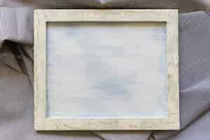 Free photo blank picture frame on striped cotton cloth