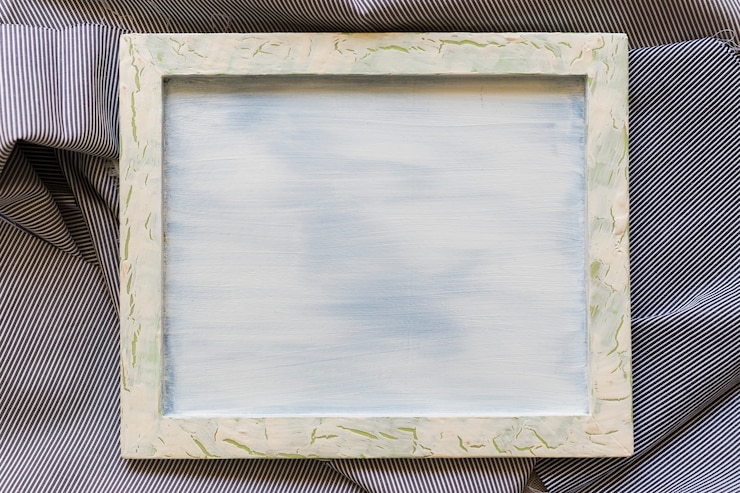 Free Photo blank picture frame on striped cotton cloth