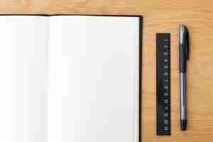 Free photo blank plain white notebook page with a pen