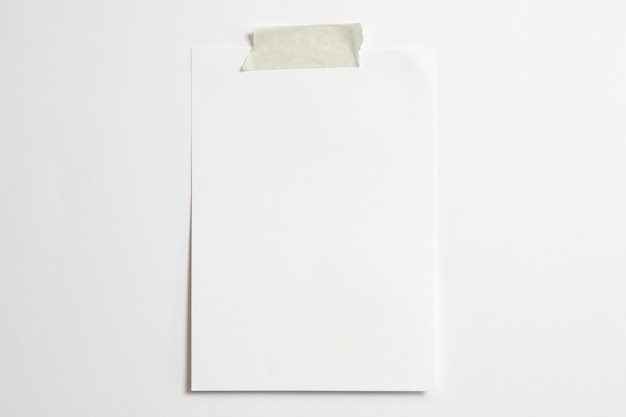 Blank portrait photo frame 10 x 15 size with soft shadows  and scotch tape isolated on white paper background 