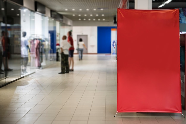 Blank red sign inside shopping mall