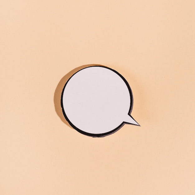 Blank round speech bubble on beige background