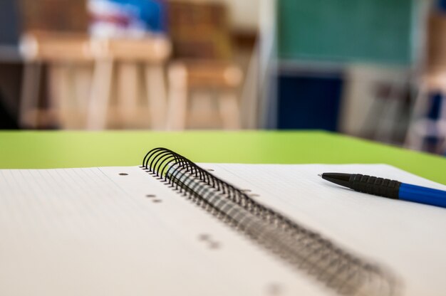 Blank scrapbook with school and office supplies on office table