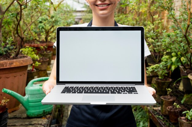 Blank screen laptop in a greenhouse