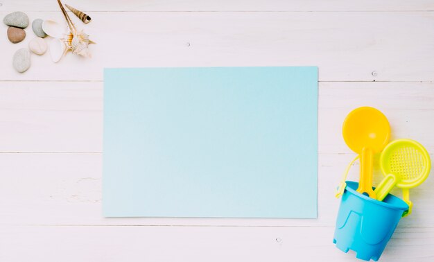 Blank sheet of paper with beach objects on light background