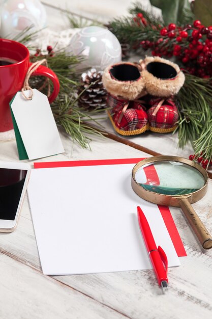 The blank sheet of paper on the wooden table with a pen