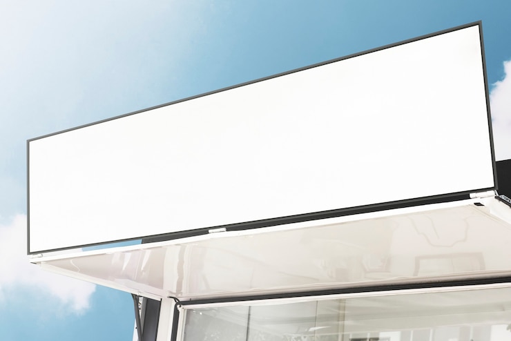 Free Photo blank shop sign against blue sky