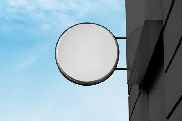 Blank shop sign against blue sky